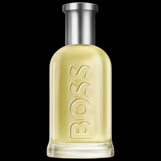 Imagen del perfume Hugo Boss Bottled EDT para hombre, frasco cilíndrico transparente con líquido dorado y tapa metálica plateada, fragancia masculina afrutada y amaderada con manzana y vainilla, disponible en Costa Rica en decants y presentación completa.